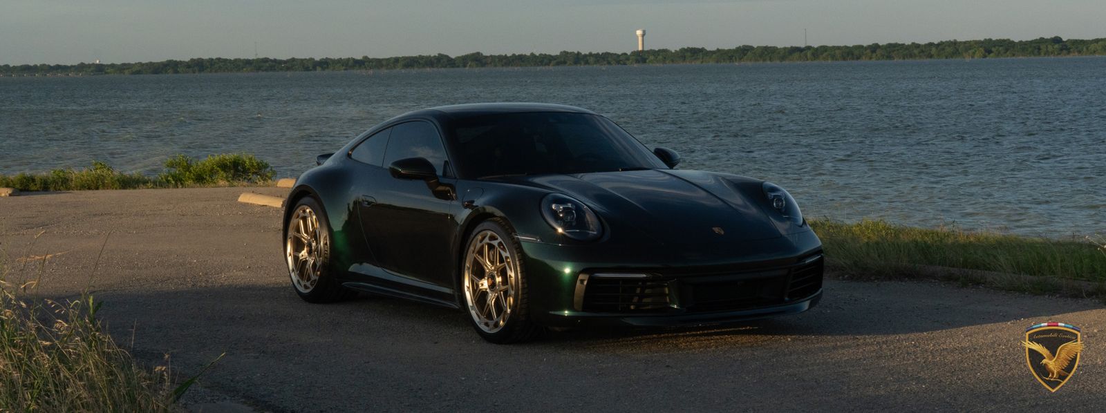 Nano Emerald Green 2023 Porsche 911 Carrera T by a lake at dusk